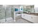 Modern bathroom featuring a glass shower, soaking tub, and double vanity sinks at 1899 Clear Sky Dr, Kissimmee, FL 34744