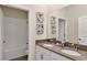 Well-lit bathroom with a double sink vanity, neutral paint, and white tiled shower/tub combo at 1899 Clear Sky Dr, Kissimmee, FL 34744