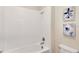 Bathroom featuring a shower and tub combo with white tile, modern vanity and neutral paint at 1899 Clear Sky Dr, Kissimmee, FL 34744