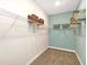 Walk-in closet with wire shelving and blue accent wall for organized storage at 1899 Clear Sky Dr, Kissimmee, FL 34744