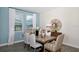 Bright dining room with natural light, a wooden table, and stylish decor elements at 1899 Clear Sky Dr, Kissimmee, FL 34744