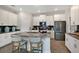Modern kitchen features stainless steel appliances, gray countertops, an island, and white cabinets at 1899 Clear Sky Dr, Kissimmee, FL 34744