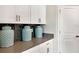 White cabinets with gray countertops, dark backsplash, with decorative jars, and stainless appliances at 1899 Clear Sky Dr, Kissimmee, FL 34744