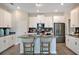 Modern kitchen features stainless steel appliances, gray countertops, an island, and white cabinets at 1899 Clear Sky Dr, Kissimmee, FL 34744