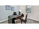 Bright home office with a modern desk, dark wood chairs and natural light from the window at 1899 Clear Sky Dr, Kissimmee, FL 34744