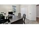 Office space with a large desk, computer, rolling chair, and natural light from the window at 1899 Clear Sky Dr, Kissimmee, FL 34744