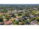 Aerial view showcasing a neighborhood with tree-lined streets, well-maintained homes and red brick roads at 2417 Coventry Ave, Lakeland, FL 33803