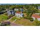 Charming two-story home with terracotta roof and manicured yard nestled amongst mature trees at 2417 Coventry Ave, Lakeland, FL 33803