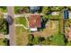 Birds eye view of a charming home with terracotta roof, patio, and landscaped yard at 2417 Coventry Ave, Lakeland, FL 33803