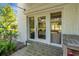 The back entrance features glass doors, stone floors, and lush landscaping, creating a welcoming transition at 2417 Coventry Ave, Lakeland, FL 33803