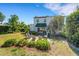 The backyard boasts a brick patio with ample seating surrounded by lush landscaping and white stucco walls at 2417 Coventry Ave, Lakeland, FL 33803
