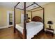 Classic bedroom with a four poster bed, bedside tables, hardwood floors and multiple windows at 2417 Coventry Ave, Lakeland, FL 33803