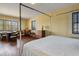 Bright bedroom with hardwood floors, three windows and matching dressers on either side of the bed at 2417 Coventry Ave, Lakeland, FL 33803