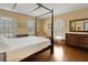 Bedroom with a four poster bed, hardwood floors, large window, and classic furnishings at 2417 Coventry Ave, Lakeland, FL 33803