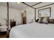 Cozy bedroom with a four-poster bed, comfortable chair, and classic wooden furniture at 2417 Coventry Ave, Lakeland, FL 33803