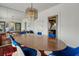 Formal dining area featuring stylish blue chairs, wood table, and decorative mirror accents for elegant meals at 2417 Coventry Ave, Lakeland, FL 33803