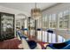 Elegant dining room with a large wood table, blue chairs, and a stylish chandelier, ideal for entertaining guests at 2417 Coventry Ave, Lakeland, FL 33803