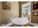 Bright dining area with natural light, a round table, and unique decor creates a cozy atmosphere for meals at 2417 Coventry Ave, Lakeland, FL 33803