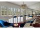 Bright dining room featuring hardwood floors, a modern chandelier, and large windows with shutter style blinds at 2417 Coventry Ave, Lakeland, FL 33803
