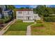 Charming two-story home featuring a terracotta roof, front balcony, manicured yard, and lush landscaping at 2417 Coventry Ave, Lakeland, FL 33803