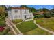 This is a stunning two-story home with a red tile roof, balcony, lush landscaping and a spacious driveway at 2417 Coventry Ave, Lakeland, FL 33803