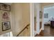 Hallway with decorative artwork leading to an adjacent room featuring a comfortable armchair at 2417 Coventry Ave, Lakeland, FL 33803