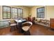Bright home office with hardwood floors and three windows bringing in natural light at 2417 Coventry Ave, Lakeland, FL 33803