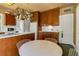 Spacious kitchen featuring wood cabinetry, a hanging pot rack, and modern appliances, designed for culinary enthusiasts at 2417 Coventry Ave, Lakeland, FL 33803