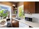 Cozy kitchen nook with stainless steel sink, vintage cabinets, and natural light creates a charming cooking space at 2417 Coventry Ave, Lakeland, FL 33803