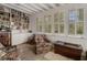 Cozy reading nook with built in bookshelves, comfortable seating, and natural light from the window at 2417 Coventry Ave, Lakeland, FL 33803