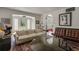 Bright living room featuring an arched doorway, stylish furniture, and natural light streaming in through large windows at 2417 Coventry Ave, Lakeland, FL 33803