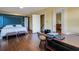 Bedroom featuring hardwood floors, a four poster bed, and a comfortable workspace at 2417 Coventry Ave, Lakeland, FL 33803