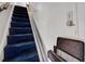 Staircase with blue carpeting and a chair lift system for easy access at 2417 Coventry Ave, Lakeland, FL 33803