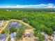 Breathtaking aerial view of a house with a private pond surrounded by lush greenery and mature trees at 9526 Turkey Oak Bnd, Orlando, FL 32817