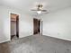 Bedroom featuring carpet flooring, ceiling fan, and two entry doorways at 9526 Turkey Oak Bnd, Orlando, FL 32817