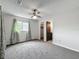 Spacious bedroom with neutral walls, carpet, ceiling fan, and access to an ensuite bathroom at 9526 Turkey Oak Bnd, Orlando, FL 32817