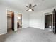 Bedroom features carpet flooring, a ceiling fan and access to a private bathroom at 9526 Turkey Oak Bnd, Orlando, FL 32817