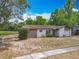 Charming single-story home featuring a well-maintained lawn and attached garage at 9526 Turkey Oak Bnd, Orlando, FL 32817