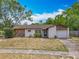 Charming single-story home with a well-maintained lawn and a driveway leading to the garage at 9526 Turkey Oak Bnd, Orlando, FL 32817