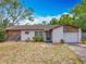 Charming single-story home featuring a well-maintained lawn and attached garage at 9526 Turkey Oak Bnd, Orlando, FL 32817