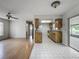 Open floorplan with wood laminate and tile flooring creates a transition to the adjacent living area at 9526 Turkey Oak Bnd, Orlando, FL 32817