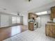 Open-concept layout showcasing living room and kitchen with a skylight at 9526 Turkey Oak Bnd, Orlando, FL 32817