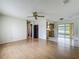 Inviting living room featuring hardwood floors, a ceiling fan, and ample natural light at 9526 Turkey Oak Bnd, Orlando, FL 32817