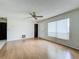Bright living room featuring hardwood floors, a ceiling fan, and a large window at 9526 Turkey Oak Bnd, Orlando, FL 32817
