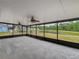 Spacious screened-in patio showcasing a tranquil view of the pond and backyard at 9526 Turkey Oak Bnd, Orlando, FL 32817