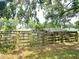 Animal shelter with wooden fence and metal roof in a pastoral landscape at 5045 Swindell Rd, Lakeland, FL 33810