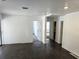 Open concept living space with dark floors and neutral wall colors at 5045 Swindell Rd, Lakeland, FL 33810