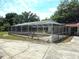 Screened in pool with concrete patio and ladder at 5045 Swindell Rd, Lakeland, FL 33810