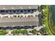 Aerial view of an organized townhouse community with manicured lawns and a nearby pond at 2352 Grand Central Pkwy # 18, Orlando, FL 32839