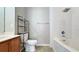 Well-maintained bathroom featuring a shower over bath, storage shelving, and wood-finished vanity at 2352 Grand Central Pkwy # 18, Orlando, FL 32839